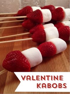 strawberries and marshmallows are arranged on sticks with the words valentine kabobs