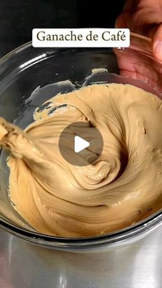 a person mixing batter in a bowl with a video screen showing how to make ganache de cafe