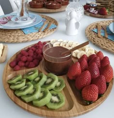 a plate with fruit, kiwis and other foods on it sitting on a table