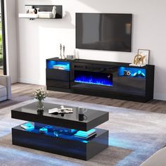 a living room with modern furniture and blue lights on the tv stand in front of it