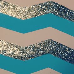 an abstract painting with blue and silver glitters on the top of it's chevron lines