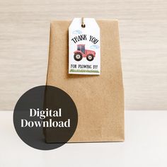 a brown paper bag with a tag that says thank you for playing in the farm