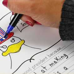 a person is writing on a paper with a pen in their hand and an image of a cartoon character