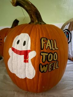 two pumpkins decorated to look like ghostes with the words fall too well written on them