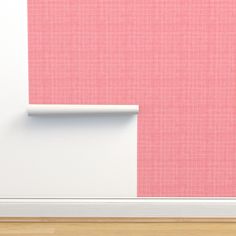 an empty room with pink and white walls