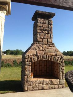 an outdoor brick oven sitting in the grass