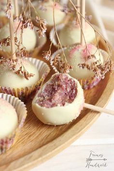 some cupcakes are sitting on a plate with sticks sticking out of the top