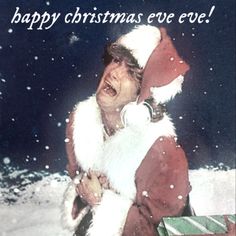 a man in a santa suit holding a box with the words happy christmas eve eve