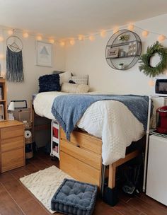 a bed room with a neatly made bed and lots of lights on the wall above it