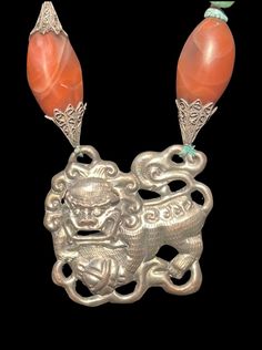 "1970's Laurel Birches Antique Foo dog Necklace.  Beautifully crafted silver plated necklace has. large center Foo Dog pendant handcrafted in repousse .  It has fine details including moveable little ears.  The necklace has various large beads made of natural materials and stones such as large red agate beads, turquoise, carved Jade Shou Beads, coral, Turquoise, carved and painted bone and silver filigree beads.  The beaded portion of the necklace hold the pendant and is attached to a silver dra Vintage Silver Carved Necklaces, Silver Vintage Carved Necklaces, Collectible Carved Pendant Necklace, Collectible Antique Silver Jewelry With Large Pendant, Antique Silver Large Pendant Collectible Jewelry, Carved Pendant Necklace Collectible, Antique Silver Large Pendant Jewelry Collectible, Antique Sterling Silver Necklaces With Lost Wax Casting, Antique Sterling Silver Necklace With Lost Wax Casting