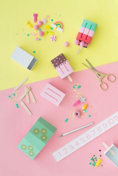 various craft supplies are laid out on a pink and yellow background