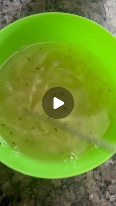 a green bowl filled with soup on top of a counter