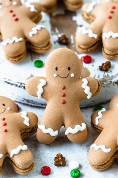 several gingerbread cookies with white icing and candy