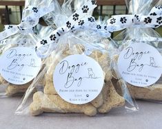 three bags filled with dog treats sitting on top of a table