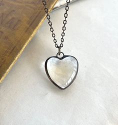 "I have soldered together 2 flat back domed heart glass pieces to create this simple heart of glass soldered pendant.  The clear glass heart measures 1\" and is soldered with lead free solder and finished with an antiqued patina.  This simple glass heart pendant hangs from a 18\" antiqued brass chain with lobster clasp.  You can choose your chain length at checkout. A lovely jewelry gift and or bridesmaid gift. Clearly simple with love. View more glass necklaces here -  https://thatoldbluehouse2 Heart-shaped Clear Jewelry For Gifts, Heart-shaped Clear Jewelry Gift, Silver Glass Jewelry With Heart Charm, Clear Heart Pendant Jewelry For Valentine's Day, Clear Heart Charm Necklace, Handmade Clear Heart-shaped Jewelry, Clear Heart Charm Necklace With Heart Pendant, Clear Glass Heart Pendant Necklace, Clear Glass Heart-shaped Jewelry