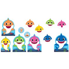 an assortment of shark shaped magnets on a white background