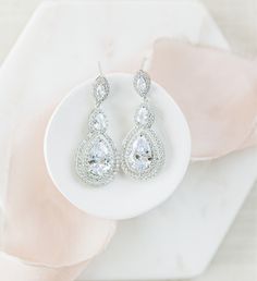 Prepare to be enchanted by the Dallas drop wedding earrings which feature shimmering cubic zirconia crystal in a teardrop design. #weddingearrings #bridaljewelry #bridalearrings #rosegold #earrings #weddingjewelry #silver #bridesmaidearrings #bridesmaidjewelry Drop Bridal Earrings, Gold Earrings Wedding, Pink Shop, Wedding Bridesmaid Jewelry, Rose Gold And Silver, Bridal Earrings Drop, Wedding Earrings Drop, Dallas Wedding, Bridesmaid Necklace