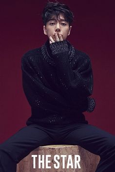 a man sitting on top of a wooden block with his hand to his mouth and the words, the star above him