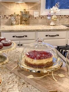 a cake covered in icing sitting on top of a counter next to other desserts