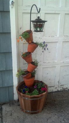 a potted planter filled with flowers next to a garage door