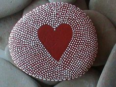 a red heart painted on top of some rocks