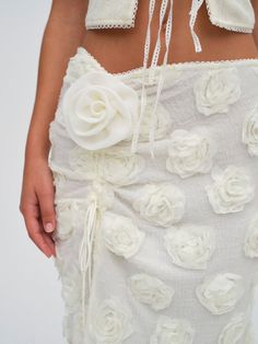 The ultimate '90s skirt silhouette—the Bailey knit skirt in cream was created for your very own love story. The perfect blend of sexy and cute, this maxi skirt features an alluring thigh-high slit adorned with a large fabric flower, and is coated in 3D rose appliques. Romantic Crochet, Bridal Intimates, Fabric Rosette, Girl Aesthetics, Black Floral Maxi Dress, Rose Skirt, Rose Applique, Knit Maxi Skirt, 3d Rose