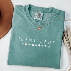 Wonderful design for women who loves Plant Lady letter design shirt.Grab this design as a gift for your girlfriend,sister,mother or who loves Plant Mom shirt.Or make yourself happy to have this cute design t-shirt :) A Plant Lady shirt is a type of t-shirt that features a design inspired by the Plant Lover Gift.Plant Lady shirts are popular among Plant Mom letter t-shirt lovers and make a great gift for any Plant Lady enthusiast. 🌿 Made from premium quality, soft cotton fabric, this shirt ensur Cotton T-shirt With Letter Print For Gardening, Green Tops With Screen Print For Gift, Green Screen Print Top As A Gift, Green Screen Print Top As Gift, Crew Neck Cotton Shirt For Gardening, Cotton Tops With Plant Print As Gift, Cotton Tops With Plants Print For Gift, Cotton Tops With Plant Print For Gifts, Cotton Tops With Plant Print