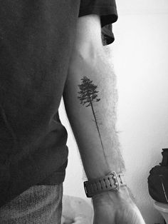 a man with a tree tattoo on his arm