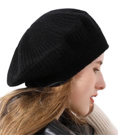 a woman with long hair wearing a black knitted beanie and looking off to the side