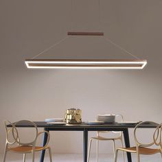 a table with chairs and a light hanging over it