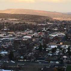 an aerial view of a city with mountains in the background