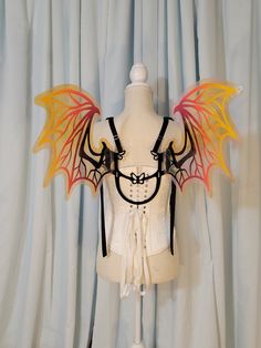 a white mannequin with wings on it