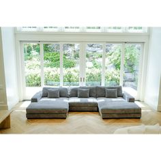 a living room with a couch and large windows