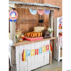 an outdoor food stand with buns, corn and hot dogs on it's sides