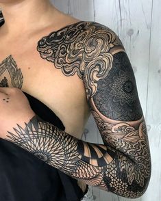 a woman with tattoos on her arm and shoulder