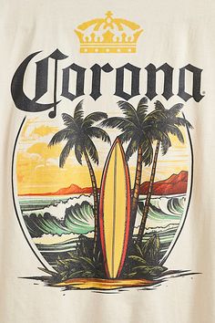 a white shirt with the words corona on it and palm trees in front of an ocean