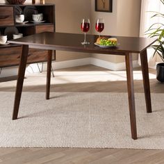 a wooden table with two glasses of wine on it