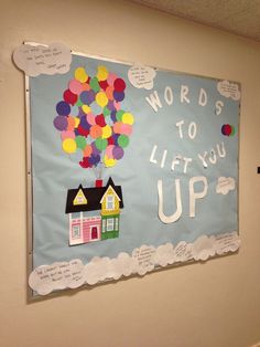 a bulletin board with words to lift you up and a hot air balloon in the sky