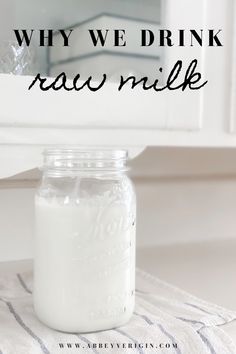 a glass jar filled with milk sitting on top of a towel