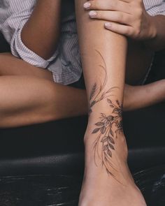 a woman's foot with a tattoo on it