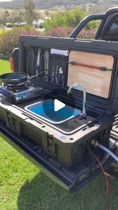 the back end of a pickup truck with an open trunk and electronics in it's compartment