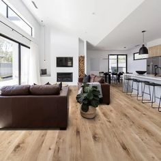 an image of a living room with wood flooring on the walls and furniture in the background