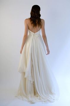 the back of a woman in a white dress