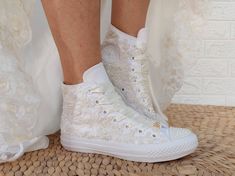 "There are many great benefits to wearing sneakers with your wedding dress - the most obvious is comfort. With a comfortable pair of tennis shoes on your feet, you will not have to avoid the track, you can easily do the laps at your reception and you will not wake up in the morning with unwanted blisters. The ivory lace with pearls in this dreamy couple is 100% worthy of a wedding. SIZE: Tip.. Its size Converse is smaller than other companies (eg. if you Nike wear 40, wear Converse 39) ★If you h Cream Lace-up Wedding Shoes For Ceremony, Cream Wedding Shoes With Laces And Round Toe, Cream Wedding Shoes With White Laces, Bridal Converse Shoes, Converse Shoes Custom, Lace With Pearls, Custom Converse Shoes, Nike Wear, Bridal Converse