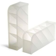 two white plastic shelves sitting next to each other