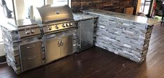 an outdoor kitchen with stainless steel appliances and wood flooring is pictured in this image