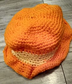 Crochet orange and yellow bucket hat is a small child's size 5 and a half inches. Casual Orange Crochet Beach Hat, Casual Orange Crochet Hat For Beach, Casual Orange Bucket Sun Hat, Orange Crochet Beach Hat One Size, Handmade Orange Crochet Hat For Beach, Orange Brimmed Bucket Hat For Spring, Handmade Orange Crochet Beach Hat, Handmade Orange Wide Brim Hat, Casual Orange Brimmed Hat