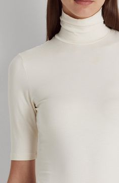 Cut from a smooth, stretchy jersey with a refined feel, this turtleneck is a chic addition to your look whether worn alone or as part of your layered look. 24" length (size Medium) Turtleneck Elbow-length sleeves 97% viscose, 3% elastane Machine wash, dry flat Imported Elegant Stretch White Turtleneck, Elegant White Stretch Turtleneck, Chic Long Sleeve Elastane Turtleneck, Chic Long Sleeve Turtleneck, Elegant Fine Knit Elastane Tops, Elegant Stretch Turtleneck In Solid Color, Elegant Mock Neck Top For Layering, Elegant Solid Spring Turtleneck, Chic Fitted Turtleneck In Solid Color