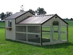 a chicken coop in the middle of a field