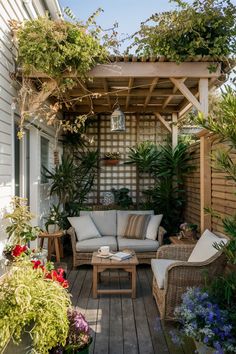 Cozy patio with wicker furniture, surrounded by potted plants and climbing vines under a wooden pergola. Small Backyard Decor Ideas, Small Backyard Decorating Ideas, Small Backyard Decor, Small Backyard Oasis, Backyard Decorating Ideas, Backyard Decor Ideas, Ladder Planter, Backyard Goals, Backyard Decorating